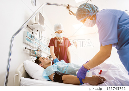 Doctors give resuscitation to a male patient in the emergency room. 123745761