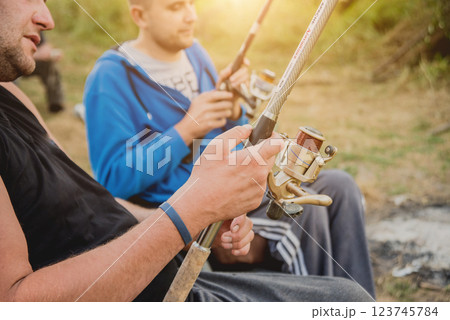 Handicapped men fishing at a lake. Wheelchair. Camping. 123745784
