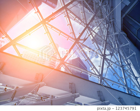 A modern tall building that features a significant amount of glass A modern tall building that features a significant amount of glass 123745791