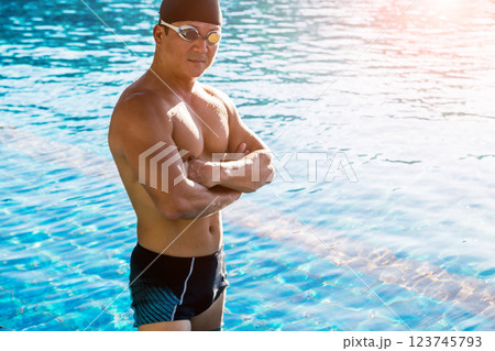 Young athletic man swimming in the swimming pool 123745793