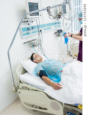 Doctors give resuscitation to a male patient in the emergency room. 123745849