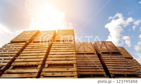 Wooden boxes stacked on each other. Outdoors. Blue sky background 123745888