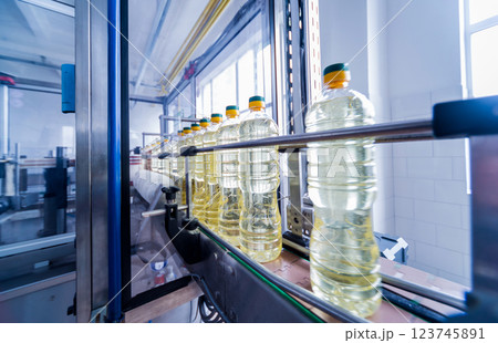 Bottling line of sunflower oil in bottles. Vegetable oil production plant 123745891
