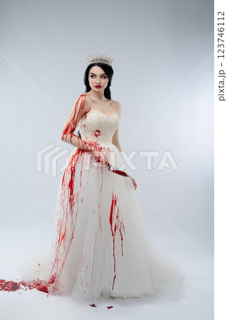 Bridal beauty covered in blood with a knife in hand symbolizing a dark fantasy 123746112