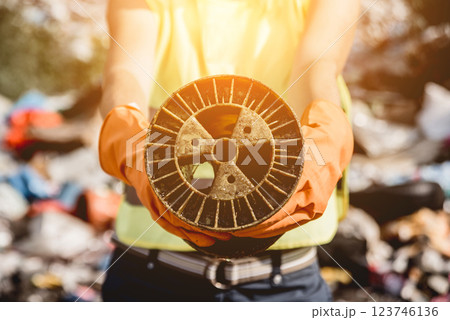 Woman volunteer helps clean the field of nuclear waste and plastic garbage. Woman volunteer helps clean the field of nuclear waste and plastic garbage. 123746136