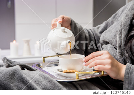 Young woman drinking herbal tea after spa procedures. Young woman drinking herbal tea after spa procedures. 123746149