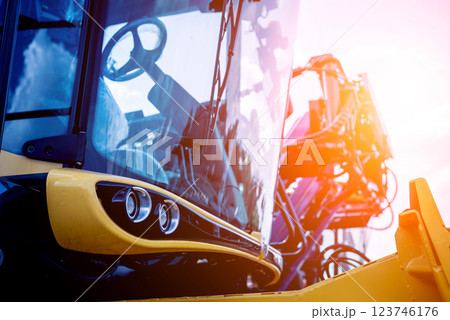 Modern agricultural machinery and equipment. Yellow agricultural harvester. 123746176