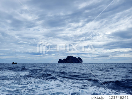 There is a small secluded island located in the middle of the ocean There is a small secluded island located in the middle of the ocean 123746241