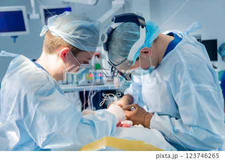 Spinal surgery. Group of surgeons in operating room with surgery equipment.  123746265