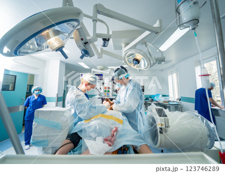 Spinal surgery. Group of surgeons in operating room with surgery equipment.  123746289
