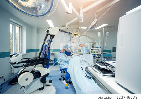 Brain surgery. Group of surgeons in operating room with surgery equipment. 123746338