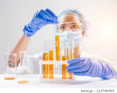 Scientist pouring organic oil. Beauty and cosmetics sciences.  123746364