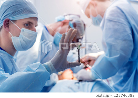 Spinal surgery. Group of surgeons in operating room with surgery equipment. Spinal surgery. Group of surgeons in operating room with surgery equipment. 123746388