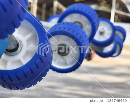 Detailed closeup of a boat trailer that features striking blue wheels 123746450