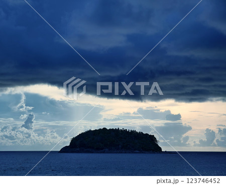 There is a small secluded island located in the middle of the ocean There is a small secluded island located in the middle of the ocean 123746452