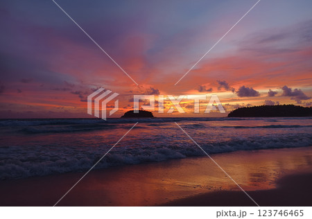 A stunning sunset is casting vibrant hues of color over a tranquil ocean 123746465