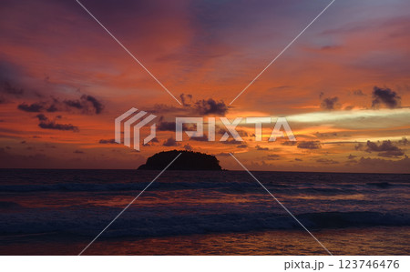 A stunning sunset is casting vibrant hues of color over a tranquil ocean A stunning sunset is casting vibrant hues of color over a tranquil ocean 123746476