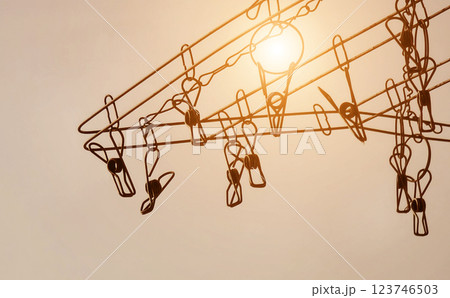 Silhouette of colorful clothespins is hanging on a clothesline 123746503