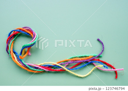 Twisted multicolored threads forming a rope. Unity and teamwork. Twisted multicolored threads forming a rope. Unity and teamwork. 123746794