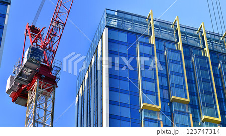 Crane on the construction site in a site surrounded by the high buildings. 123747314