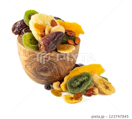 Dried tropical fruits, nuts, and raisins isolated on white. 123747845