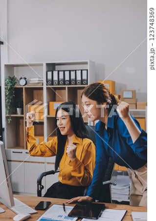 Asian SME business women use laptop computer checking customer order online shipping boxes at home. Starting Small business entrepreneur SME freelance. Online business, Work at home concept. 123748369