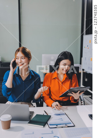Entrepreneur Asian businessman and businesswoman discussing new business project in tablet in modern Meeting In Modern Office, Asian business casual concept. Entrepreneur Asian businessman and businesswoman discussing new business project in tablet in modern Meeting In Modern Office, Asian business casual concept. 123748385