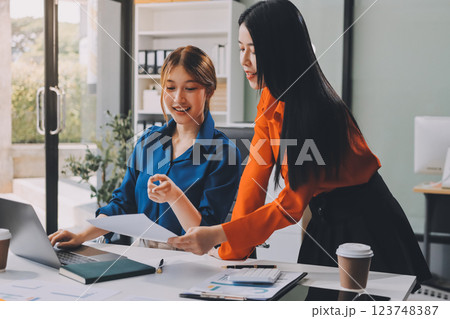 Entrepreneur Asian businessman and businesswoman discussing new business project in tablet in modern Meeting In Modern Office, Asian business casual concept. Entrepreneur Asian businessman and businesswoman discussing new business project in tablet in modern Meeting In Modern Office, Asian business casual concept. 123748387