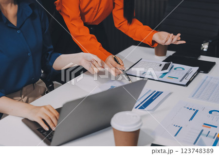 Entrepreneur Asian businessman and businesswoman discussing new business project in tablet in modern Meeting In Modern Office, Asian business casual concept. 123748389