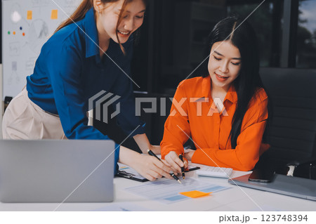Entrepreneur Asian businessman and businesswoman discussing new business project in tablet in modern Meeting In Modern Office, Asian business casual concept. Entrepreneur Asian businessman and businesswoman discussing new business project in tablet in modern Meeting In Modern Office, Asian business casual concept. 123748394