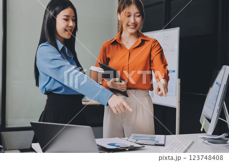 Entrepreneurs and business people conference in modern meeting room, happy multiracial coworkers have fun cooperating working together at office meeting, asian teamwork concept 123748408