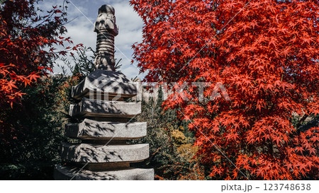 A Serene Stone Sculpture Graces the Scene, Surrounded by Vibrant Autumn Foliage and Colors 123748638