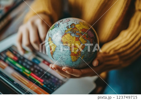 A woman is holding a globe on a tablet, Online marketplace with global discounts concept 123749715