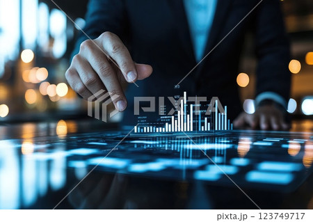 A man is pointing at a graph on a computer screen 123749717