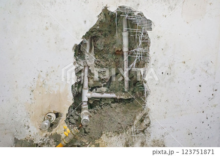 Hole in old building, drain pipes 123751871