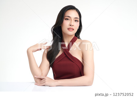 A beautiful young Asian woman with clean, fresh skin against a white background. She represents beauty, skincare, and spa treatments. 123752052