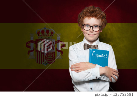 Smiling schoolboy child on Spanish flag background. Education and childhood in Spain concept 123752581