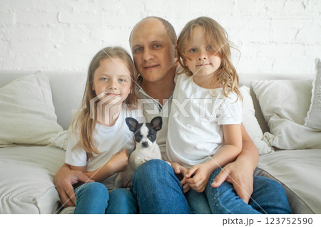 Happy father with two daughters and dog pet at home, portrait Happy father with two daughters and dog pet at home, portrait 123752590