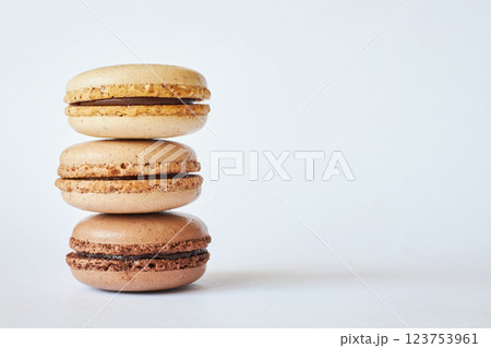 Stack of three brown French Macarons, cakes with coffee and creme brulee flavor Stack of three brown French Macarons, cakes with coffee and creme brulee flavor 123753961