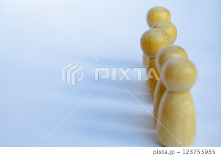 A wooden figure looking at the direction. Representing satisfaction or happy with something 123753985