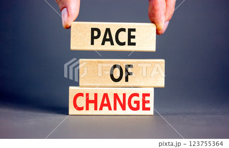 Pace of change symbol. Concept words Pace of change on beautiful wooden blocks. Beautiful grey background. Businessman hand. Business pace of change concept. Copy space. 123755364
