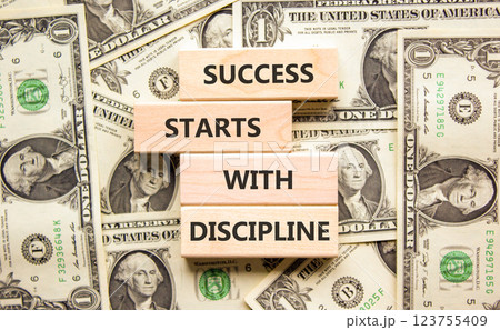 Success starts with discipline symbol. Concept words Success starts with discipline on beautiful wooden blocks. Beautiful dollar background. Business success starts with discipline concept. Copy space 123755409