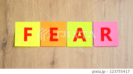 Fear symbol. Concept word Fear on beautiful colored paper. Beautiful wooden table wooden background. Business, lifestyle and fear concept. Copy space. Fear symbol. Concept word Fear on beautiful colored paper. Beautiful wooden table wooden background. Business, lifestyle and fear concept. Copy space. 123755417