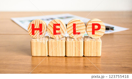 Help symbol. Concept word Help on beautiful wooden circles on wooden blocks. Beautiful wooden table white background. Business, lifestyle, support and help concept. Copy space. 123755418