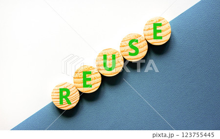 Reuse symbol. Concept word Reuse on beautiful wooden circles. Beautiful white and blue background. Business lifestyle ecological reuse concept. Copy space. 123755445