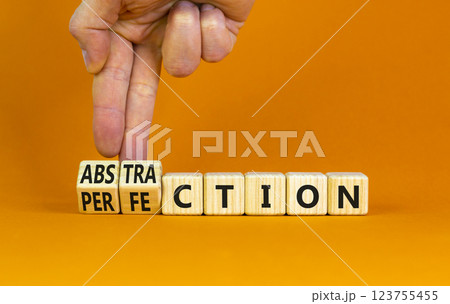 Perfection or abstraction symbol. Concept words Perfection Abstraction on beautiful wooden blocks. Beautiful orange background. Businessman hand. Business perfection or abstraction concept. Copy space Perfection or abstraction symbol. Concept words Perfection Abstraction on beautiful wooden blocks. Beautiful orange background. Businessman hand. Business perfection or abstraction concept. Copy space 123755455
