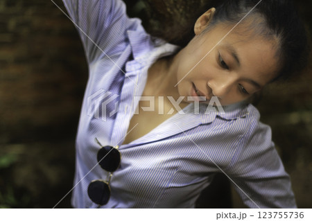 Indonesian girl posing by a tree 123755736