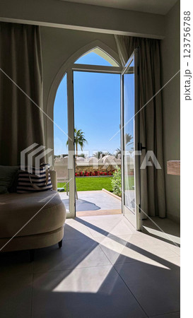 Interior view of a resort room with an arched doorwa 123756788