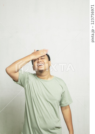 Asian man with glasses holding forehead feeling dizzy isolated on white background Asian man with glasses holding forehead feeling dizzy isolated on white background 123756971