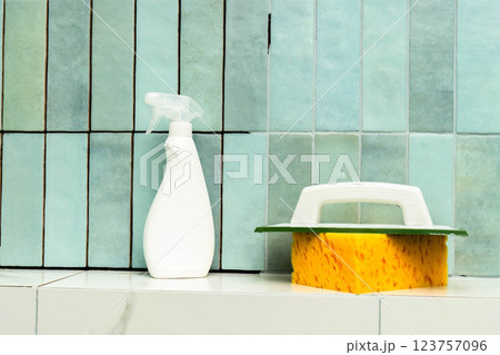 Cleaning supplies and tools for epoxy grout repair sit next to tiled surface, preparing for use. Cleaning supplies and tools for epoxy grout repair sit next to tiled surface, preparing for use. 123757096